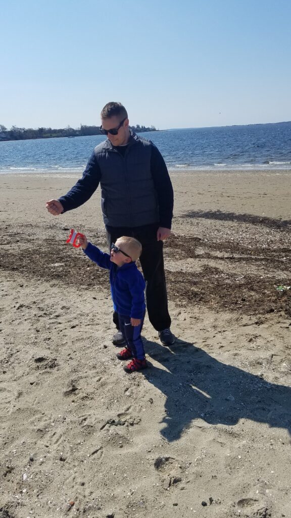 person playing with child on a beach