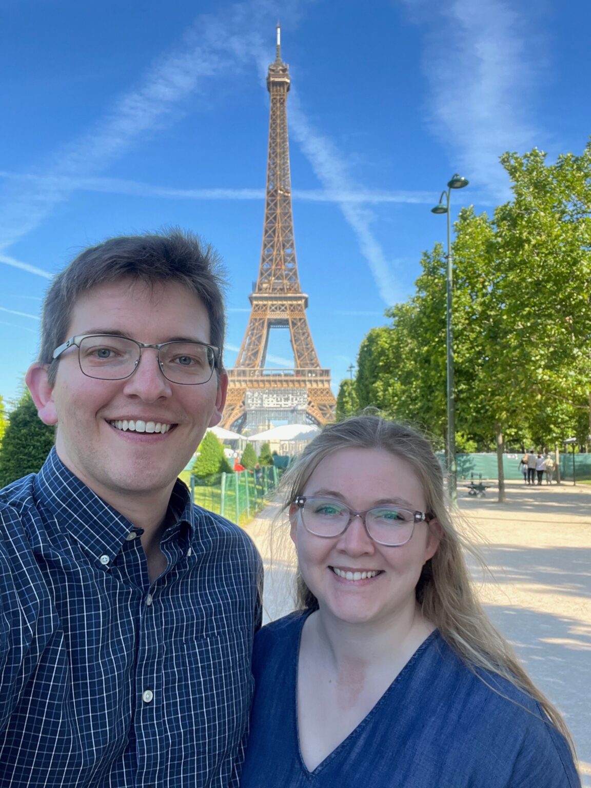 two people posing in front of the Eiffel Tower