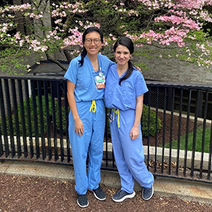 two people in hospital scrubs posing for a photo